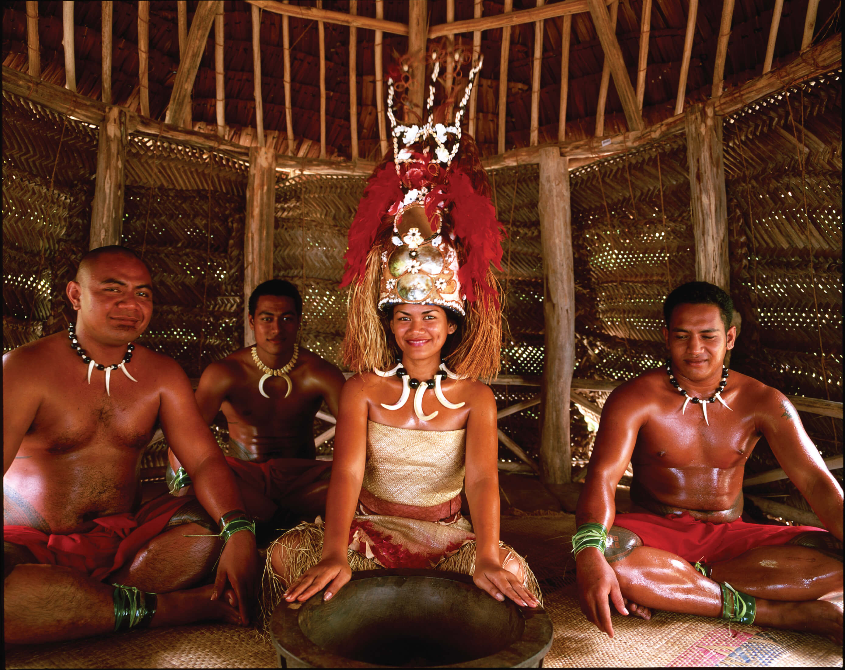 group of Samoans sitting in traditional outfits 